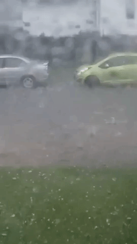 Large Hail Plunges Into Flooded Street in Calgary