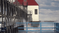 Waves Crash Against Lake Michigan Lighthouses 
