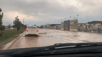 Cars Drive Through Water as Death Toll in Erbil Floods Rises