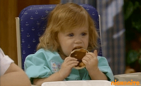 TV gif. One of the Olsen twins, as Michelle on Full House, licks a pancake she's holding and then looks up with disgust.