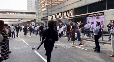 Bystanders in Hong Kong's Central District Applaud as Protesters Run By