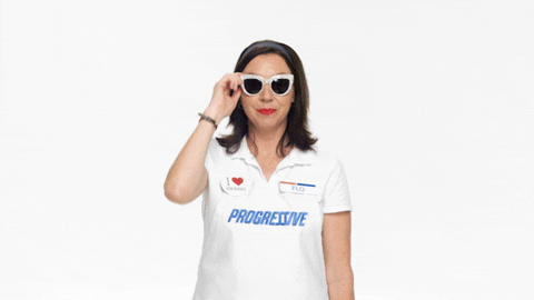 Ad gif. Flo from Progressive pulls her sunglasses down and winks at us. Her wink sparkles. 