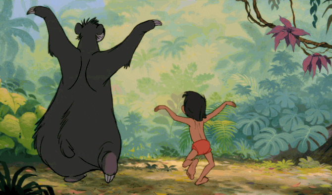 Disney gif. Baloo and Mowgli in "The Jungle Book," dancing in unison and clapping their hands over their heads.