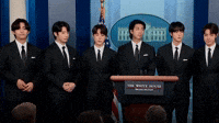 V and Jungkook react during press conference.