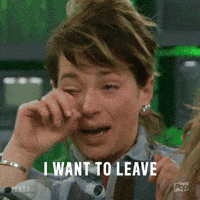 Reality TV gif. A crying Sam Bledsoe from Big Brother wipes her eyes with both hands. Text, "I want to leave."