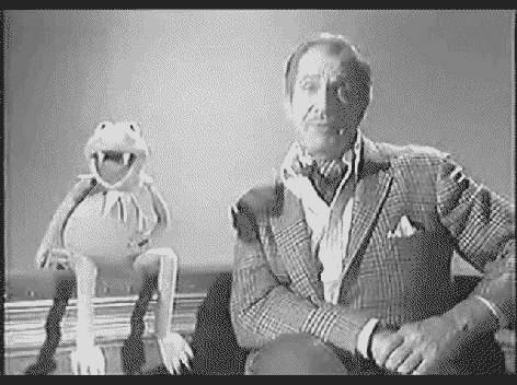 Muppets gif. In black and white, an ominous Kermit the Frog with vampire's teeth lunges toward Vincent Price, biting him in the neck. Price screams in terror as Kermit clamps down.