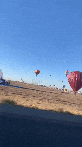 Colorful Hot Air Balloons Dot Albuquerque Sky During Annual Balloon Fiesta