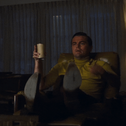 Meme gif. The Pointing Rick Dalton meme. In a scene from Once Upon a Time in Hollywood, Leonardo DiCaprio as Rick Dalton sits up from an armchair and points intently out of frame.