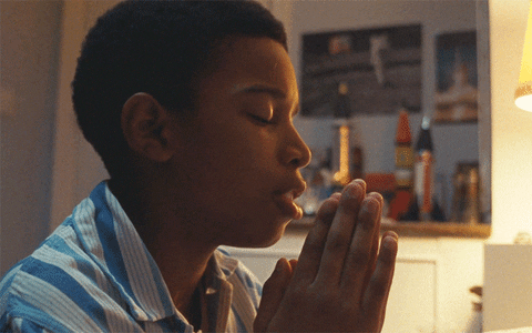 Movie gif. Kenyah Sandy as Kingsley in Small Axe Education with his palms together in prayer.