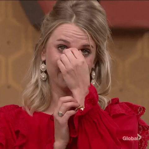 Reality TV gif. An overwhelmed and teary-eyed Nicole Franzel from Big Brother fans herself with her hands.