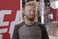 Sports gif. UFC Fighter Charles Oliveira shrugs, smiling and nodding to affirm us.