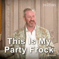 Sponsored gif. Traitors cast member Lord Ivar Mountbatten walks into a room wearing a velvet smoking jacket decorated with gold fleur-de-lis details. Text reads, “This is my party frock.”