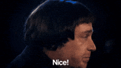 Video gif. A man turns towards us abruptly and says, "Nice!"