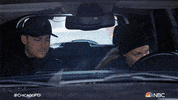 TV gif. Jesse Lee Soffer as Jay and Tracy Spiridakos as Detective Hailey in Chicago PD. They're on a stakeout in a car and Hailey is looking out her window and Jay takes this chance to pick up her coffee and take a sip. She catches him and stares.