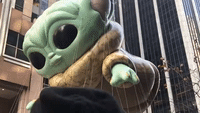 Crowd Marvels at Baby Yoda Balloon at Macy's Thanksgiving Day Parade in New York City
