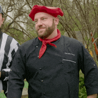 Video gif. Man wearing a chef's outfit stands with his hands on his hips and he looks lively as he says, "Yeah, you're DAMN RIGHT!"