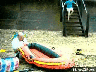 Video gif. Boy runs down the stairs and hops on the side of an inflatable boat as a man blows it up with his mouth. When the boy plops down on the boat, the air pushes to the other side and into the man’s mouth, causing his head to explode.