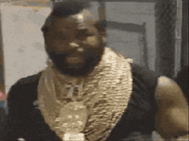 Celebrity gif. Mr. T dances, moving robotically, and using his hands to pivot his head to the side.