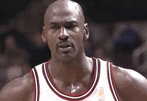 Celebrity gif. Michael Jordan stands in a jersey and shakes his head in disbelief.