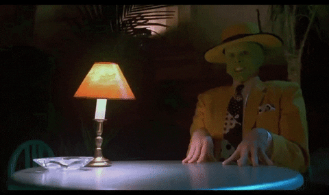 Movie gif. Jim Carrey as the the Mask sits at a nightclub table. His jaw drops open in a cartoonish way, super long tongue rolling out onto the table, and eyes bursting forward.