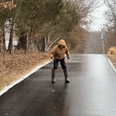 Boy Slips and Slides Down Frozen Street
