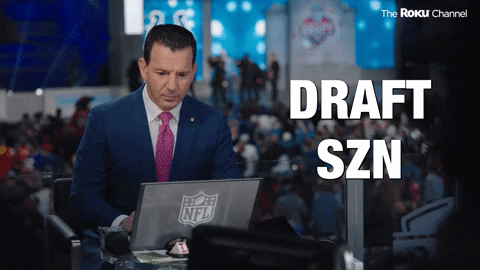 Sports gif. Ian Rapoport, a sports reporter, looks up from his laptop with an excited expression and claps his hand. He says, "The pick is in!'