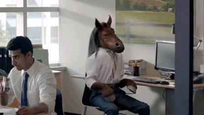 Ad gif. In a Starbucks advertisement, Man in an office sips from a canned drink while a person with a horse head and arms spins around toward his keyboard and neighs, shaking his head.