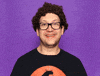 Video gif. Man looks at us with a big smile and lifts two thumbs up. More hands with thumbs up pop up on either side of his head.