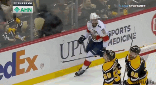 Sports gif. Slow motion clip of Aaron Ekblad of the Florida Panthers passionately yelling as he skates along the ice during a hockey game. 