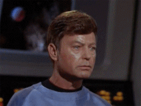TV gif. DeForest Kelley as Leonard McCoy and William Shatner as Captain Kirk exchange friendly, affirmative nods with each other.