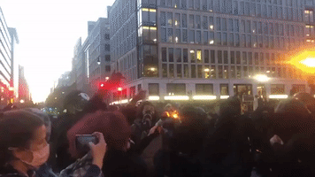 Counter-Protesters Set Flag Ablaze During Million MAGA March in Washington, DC