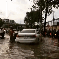 Motorists Negotiate Flooded Streets of Ho Chi Minh City