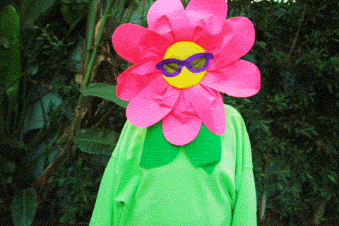 Video gif. A person wearing a flower costume with pink petals and sunglasses does a facepalm. Text, "Uuugghh." 