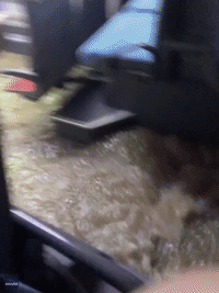Passengers Lift Their Feet as Floodwater Rushes Inside Bus in France