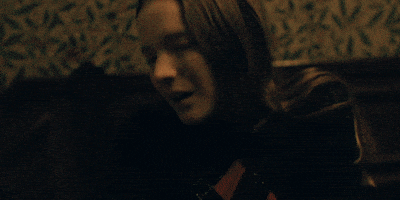 Movie gif. Morfydd Clark as Maud in Saint Maud tilts her head up and she collapses backwards slowly.