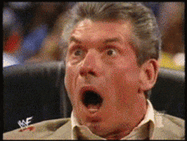 Sports gif. Vince McMahon is wide-eyed with shock as his mouth gapes open and he topples over backward in an office chair.