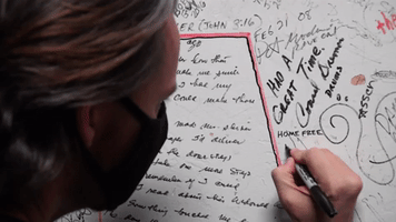 Tim Foust signing the Surf Ballroom green room wall