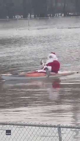 Santa Spotted Kayaking Through Flood