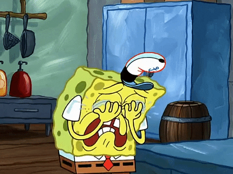SpongeBob gif. SpongeBob is hunched over, covering his big eyes with his little hands as he sobs uncontrollably in the kitchen of the Krusty Krab. 