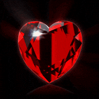 Digital art gif. Red diamond shaped like a heart spins around in a circle.