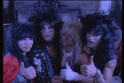 Music video gif. From Motley Crue’s Smokin' in the Boys Room video, the band smiles and nods and gives us a thumbs up as if to say, “Good job.”