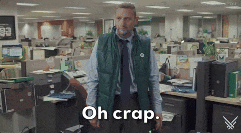 Video gif. Comedian Tim Robinson standing alone in an empty office says, "Oh crap." as the caption at the bottom of the gif reads.