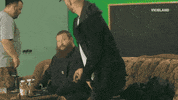 Photo gif. We zoom in on a bearded Action Bronson as a lime green alien face covers his. Text, "Welcome back."
