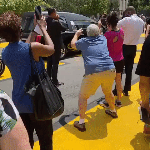 Harmonica Player Performs 'Amazing Grace' as Hearse Carrying John Lewis Stops at BLM Mural