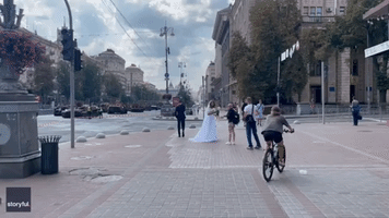 Couple in Wedding Attire Photographed With Destroyed Russian Military Equipment in Kyiv