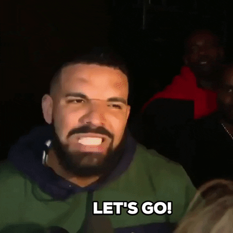Video gif. Actor and rapper Drake screams Let's go! in a crowd of people and photographers.