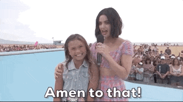 TV gif. Standing on a skateboard ramp, Lucy Hale puts her arm around Sky Brown, who looks up at her eagerly, while Lucy says into a microphone, "Amen to that!" which appears as text.