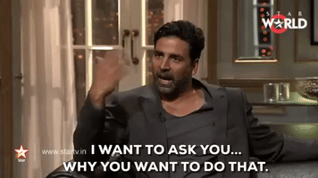 Reality TV gif. Akshay Kumar on Koffee with Karan sits with authority and levelheadedly asks someone, "I want to ask you...Why would you do that," which appears as text.