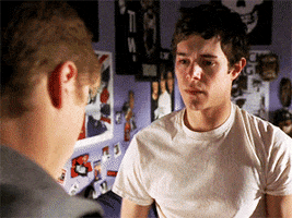 TV gif. Adam Brody as Seth Cohen from The O.C. pulls Ben McKenzie playing Ryan Atwood in for an unexpected hug. At first, Atwood doesn't know how to react, but he slowly returns the gesture.