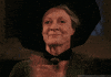 Movie gif. Maggie Smith as Professor McGonagall applauds with tears in her eyes, proud.